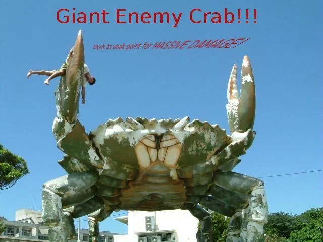 A classic image macro combining the giant crab statue with the meme's signature 'attack its weak point for massive damage' catchphrase from the E3 2006 Genji presentation.