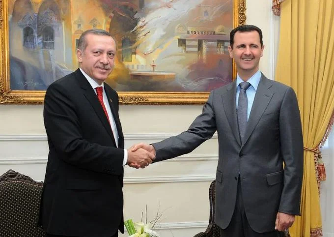 Erdogan meets and shakes hands with Syrian President Bashar al-Assad during earlier diplomatic relations between the two countries.