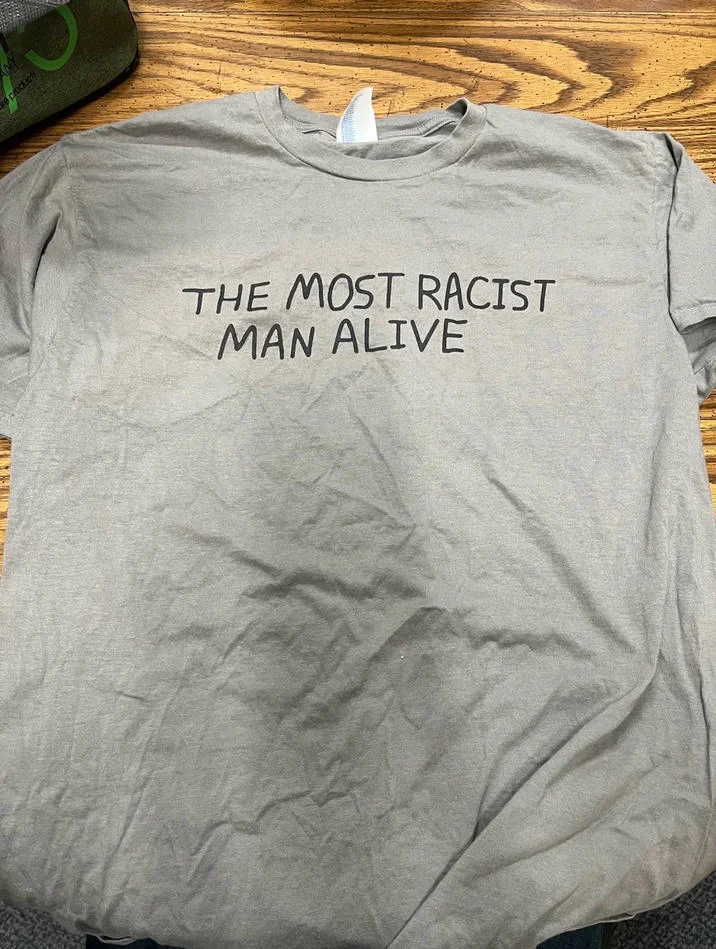 A real 'Most Racist Man Alive' t-shirt produced as merchandise inspired by the viral cartoon.