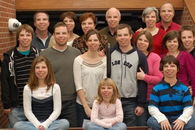 A group portrait illustrating the uncanny facebomb effect when multiple faces appear duplicated or morphed within the same photo.
