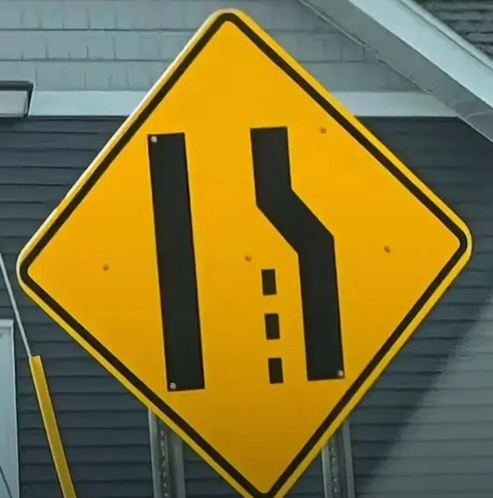 A lane merge road sign spotted in the wild that fans compared to the meme format.