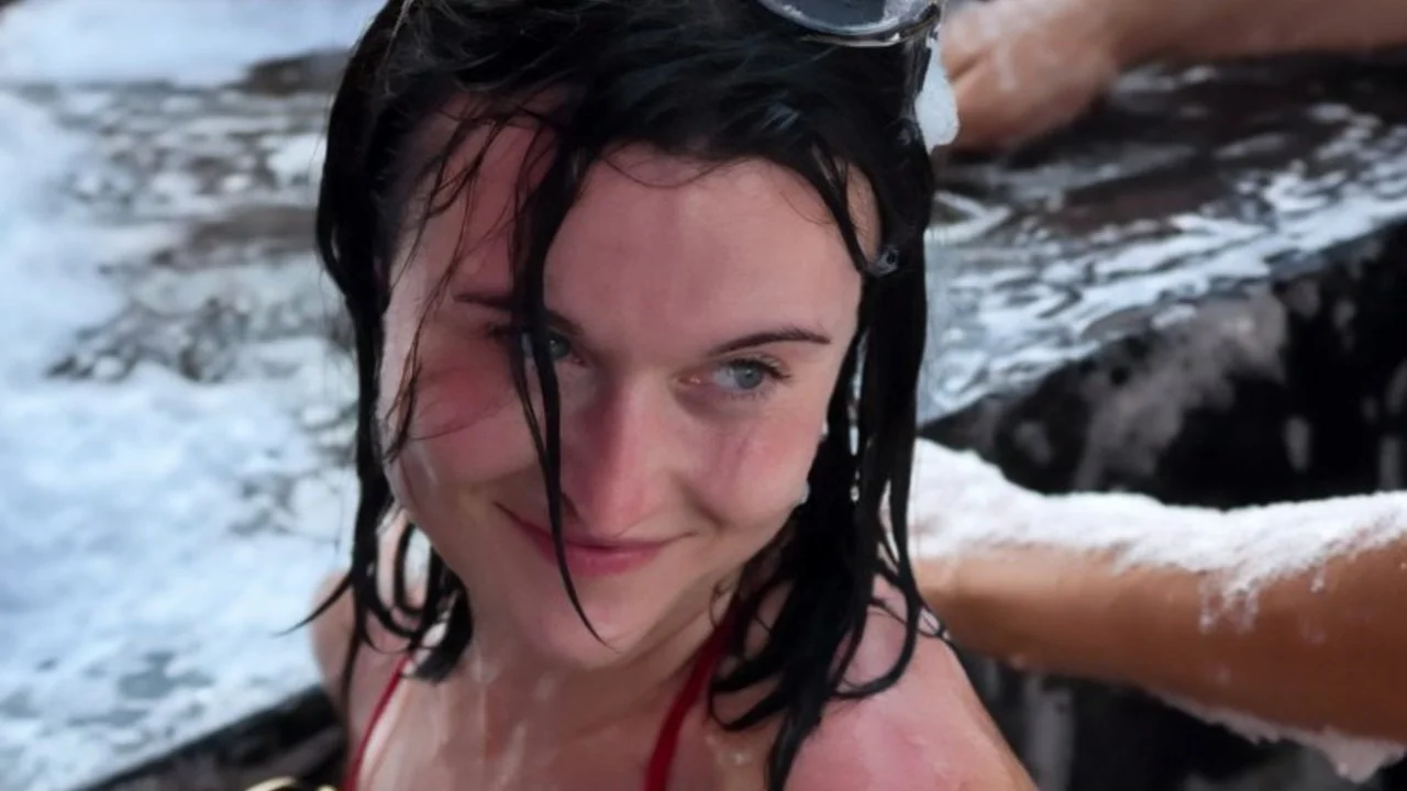 The iconic close-up of the 'foam party girl' giving her signature flirtatious look toward the camera.