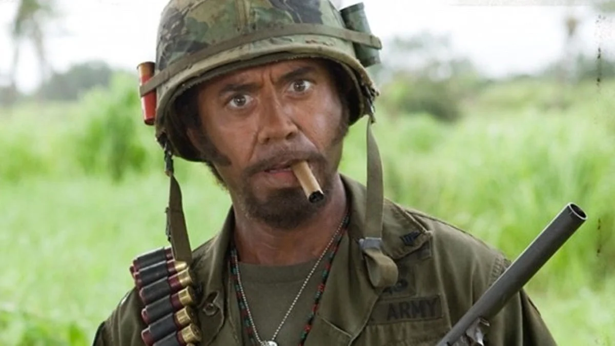 The source scene from Tropic Thunder (2008) featuring Robert Downey Jr.'s character Kirk Lazarus, from which the 'never go full retard' line originates.