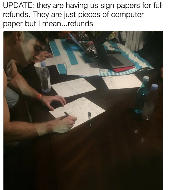 Attendees signing improvised paper 'refund forms' as Fyre Festival collapsed around them.