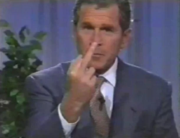 Viral footage of George W. Bush appearing to give the middle finger while adjusting his face during a television appearance.