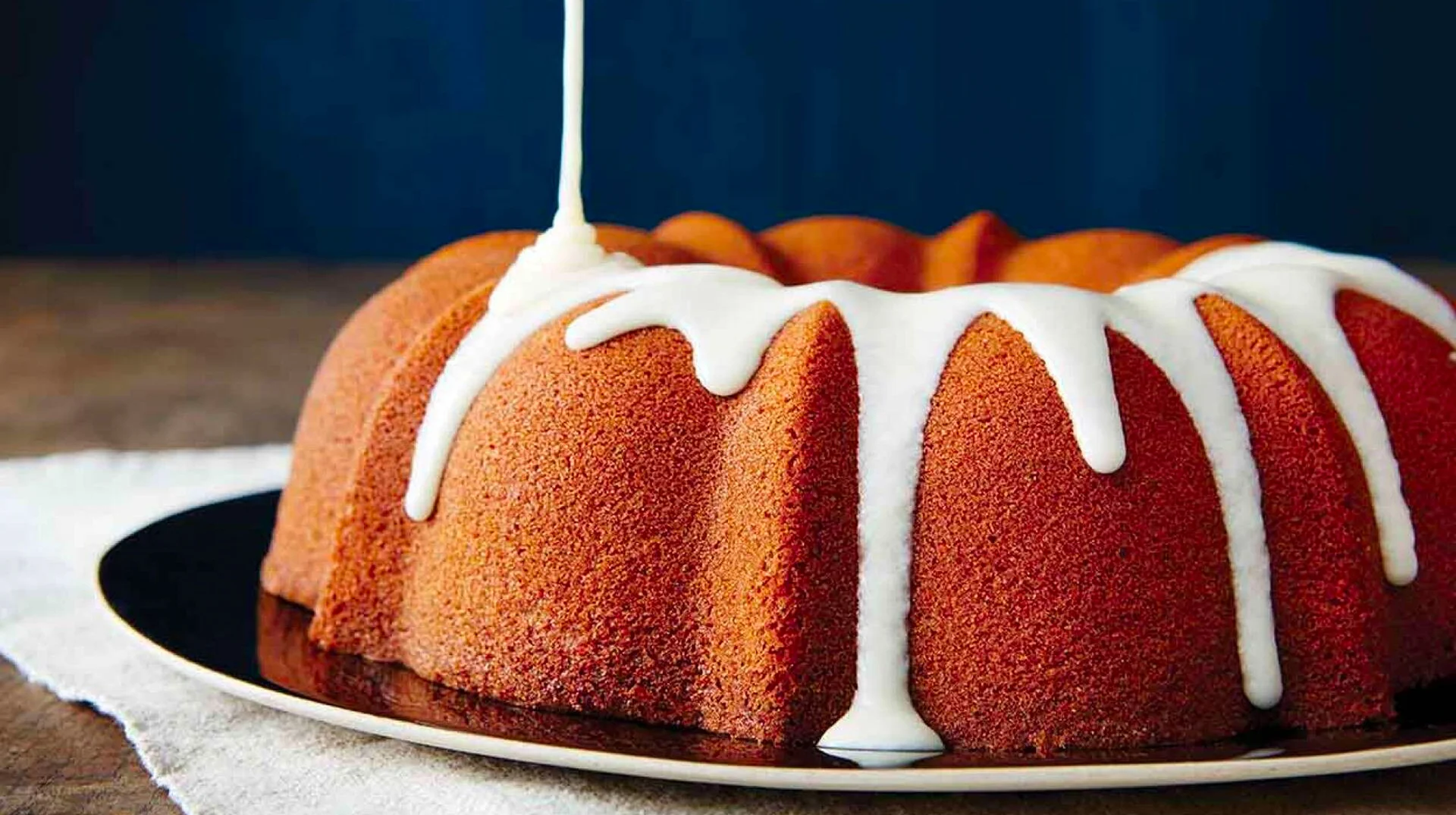 A glazed bundt cake, used as the icon image referencing the literal meaning of 'glazing' behind the slang term.