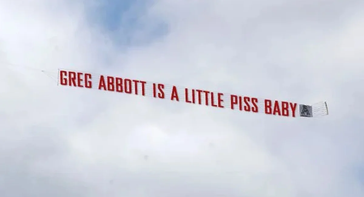 The aerial banner that was flown over Texas in September 2022, displaying the viral phrase.