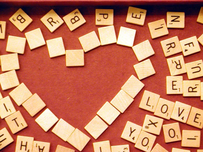 A romantic arrangement of Scrabble tiles, from Hasbro's iconic word-building board game.