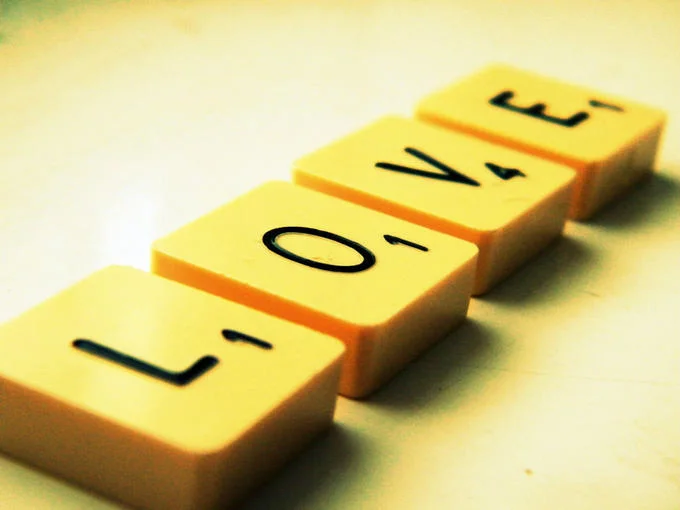 Scrabble tiles, from the classic Hasbro-owned word game, arranged to spell 'LOVE'.