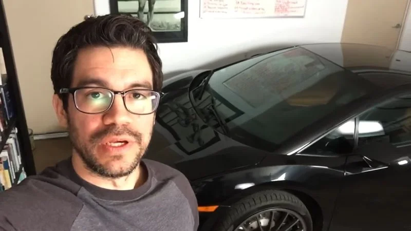 The core 'Here in My Garage' meme template with luxury vehicle.