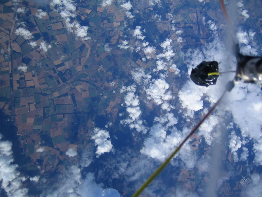 An animated look from inside a stratospheric jump capsule, referencing the professional high-altitude balloon footage that inspired amateur imitators.