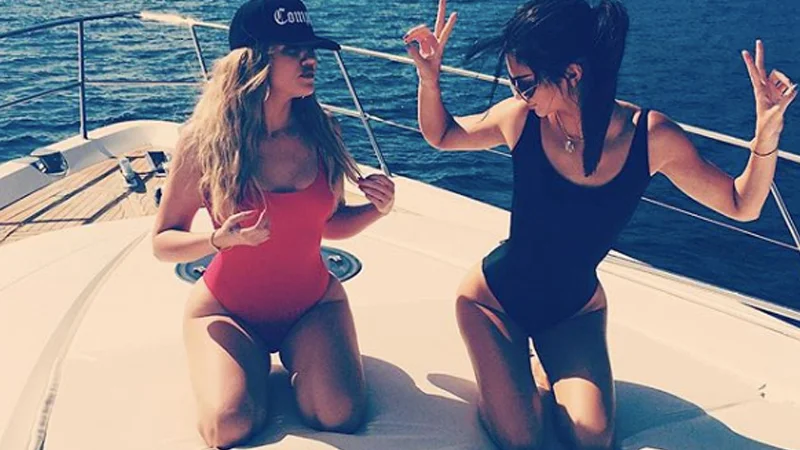 Khloé Kardashian and Kendall Jenner popularized the 'hip cleavage' look with their high-cut one-piece swimsuits on a yacht.