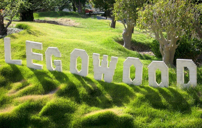 Legoland features a 'LEGOWOOD' sign built entirely from LEGO bricks, a playful parody of the Hollywood landmark.