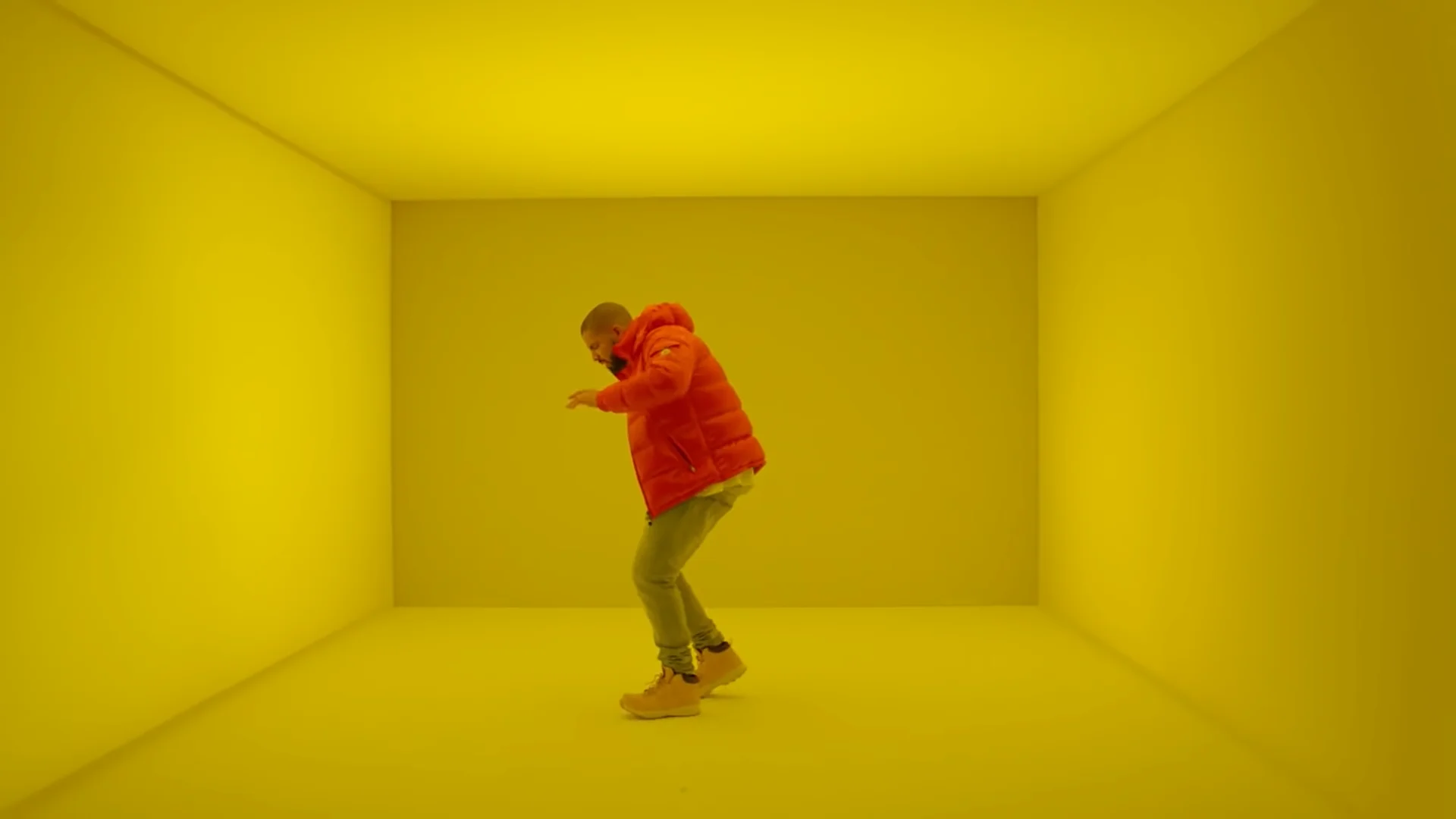 A screenshot of Drake dancing in the yellow room from the 2015 'Hotline Bling' music video, the source clip for the meme.