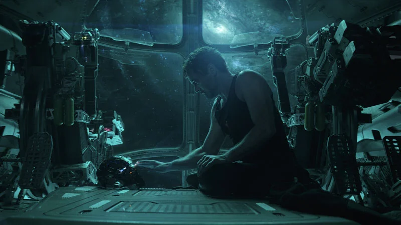 A promotional still from Avengers: Endgame featuring Tony Stark, whose emotional exchange with his daughter popularized the phrase 'I love you 3000.'