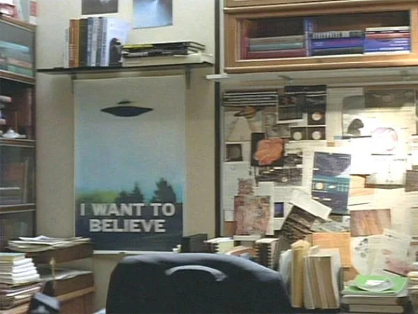 The 'I Want to Believe' poster in its original setting on Fox Mulder's office wall in The X-Files.