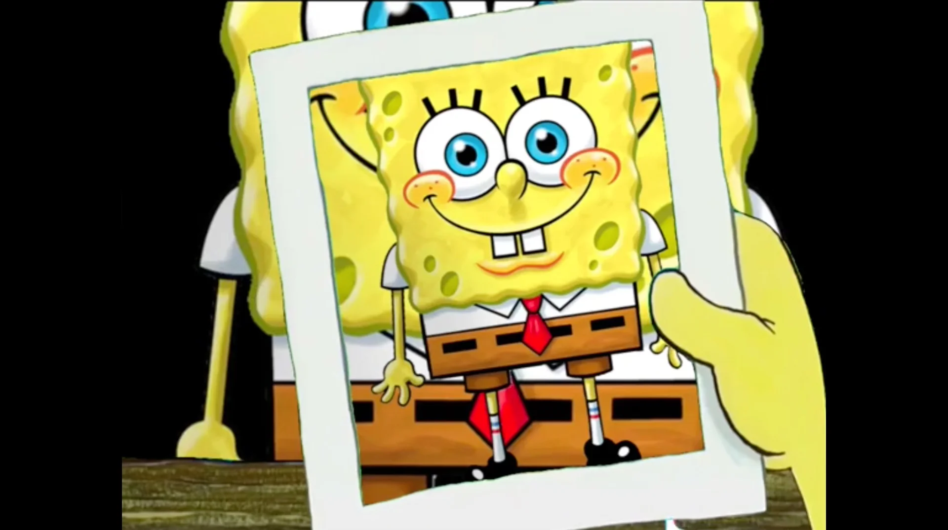 The iconic scene from SpongeBob SquarePants where SpongeBob presents a framed picture of himself, the source of the 'I'm SpongeBob' meme.