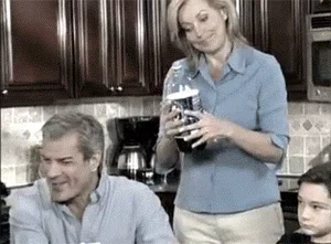 Woman struggling with kitchen appliance.