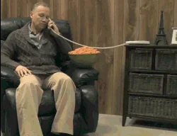 Absurd snacking struggle while on phone.