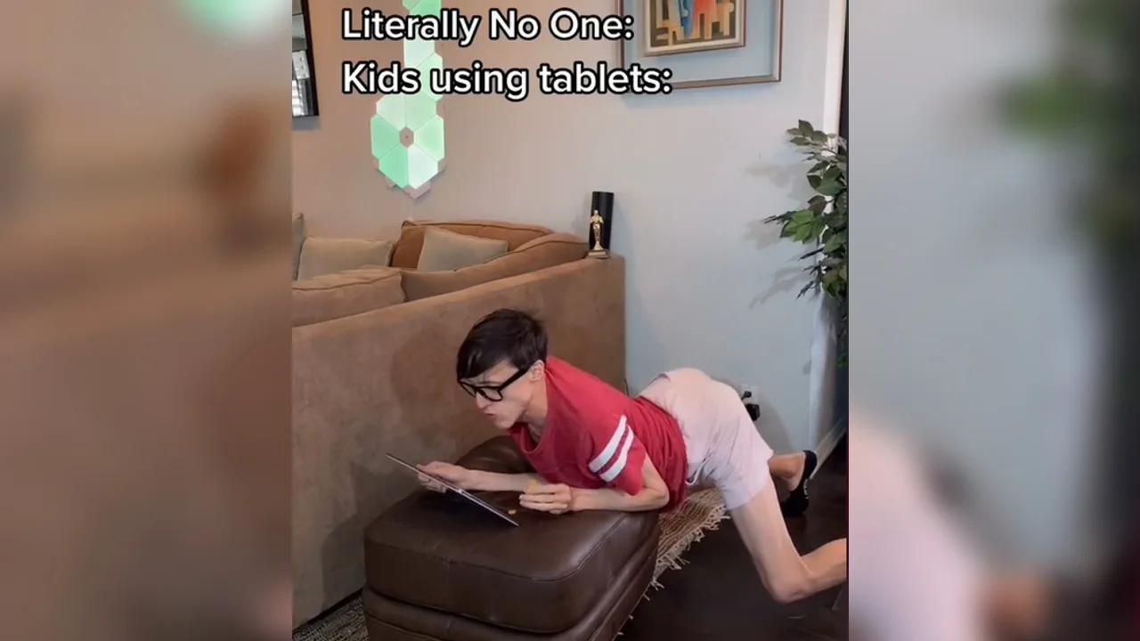 A viral TikTok skit exaggerating the hunched, screen-glued posture associated with the 'iPad kid' stereotype.