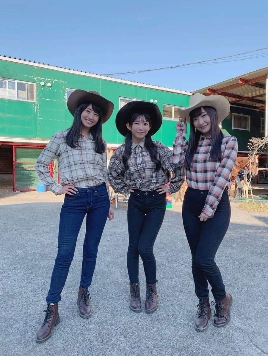 Three Japanese women dressed in western cowgirl attire, illustrating Japan's playful adoption of foreign fashion styles.