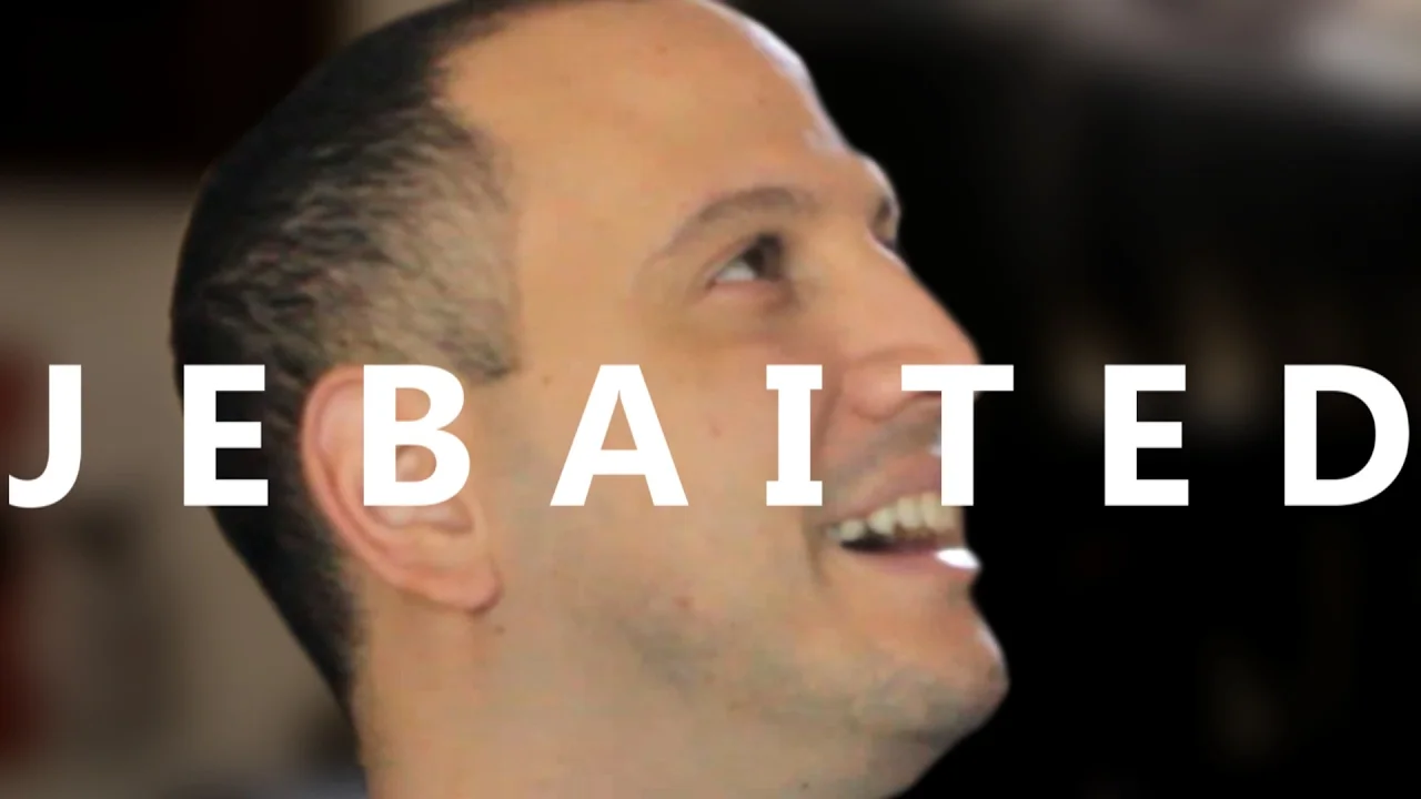 The iconic 'Jebaited' emote image featuring Alex Jebailey's grinning face, which became a widely used Twitch emote signaling that someone has been baited or tricked.