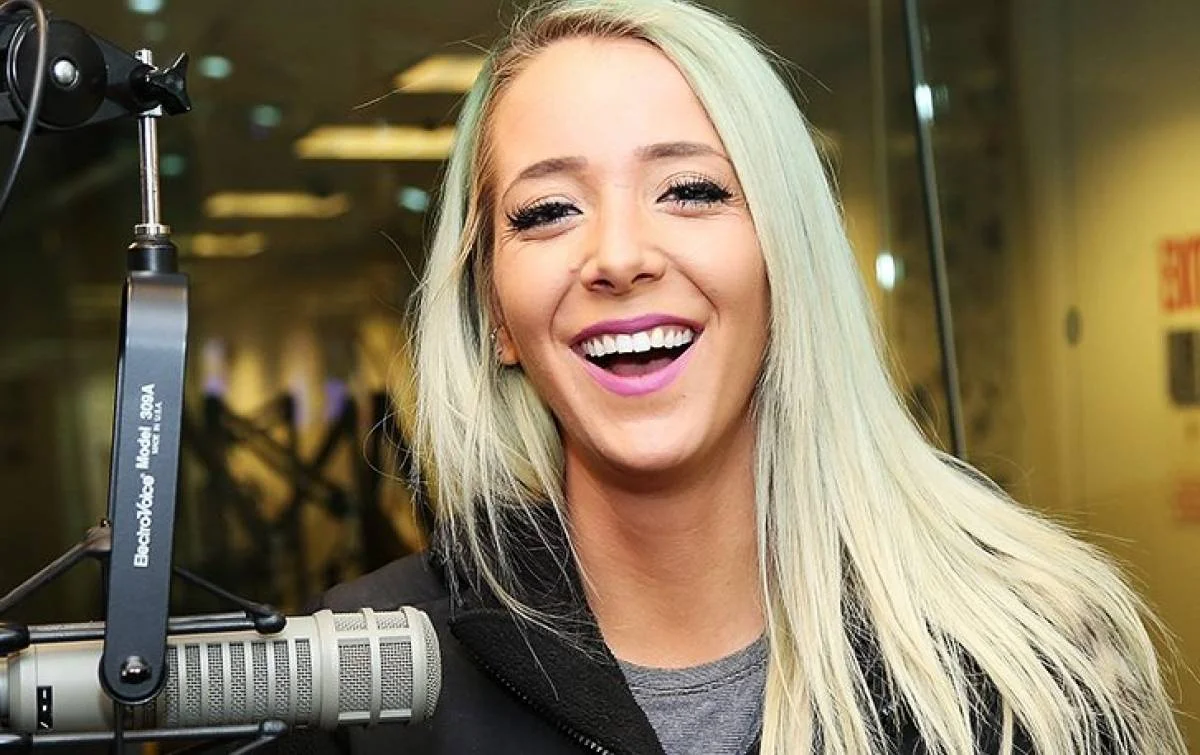 Jenna Marbles during a radio studio appearance, showcasing her signature bright blonde hair and cheerful personality.