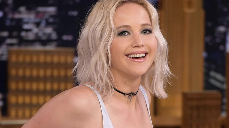 Jennifer Lawrence smiling during a late-night talk show appearance.