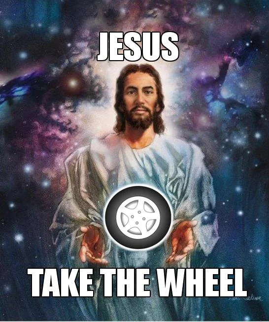 A literal visual interpretation of the phrase 'Jesus take the wheel,' placing a car wheel directly into a classic Jesus portrait.