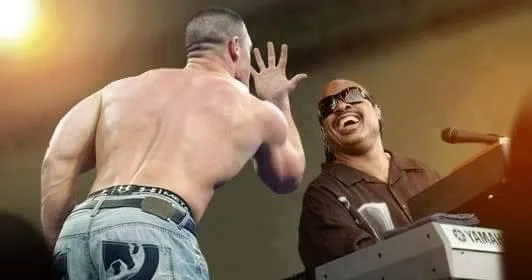 The original wrestler performing the signature hand taunt.