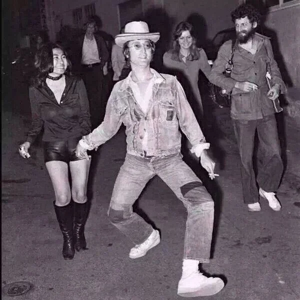 The original photograph of John Lennon mid silly-walk that spawned the 'Absolute Madman' meme.