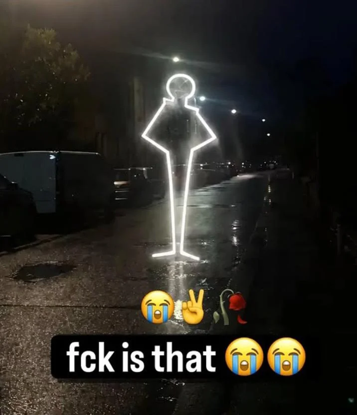 A viral meme edit inserting a glowing John Rod into a real-world street photo, playing on how surreal the stand looks in any setting.