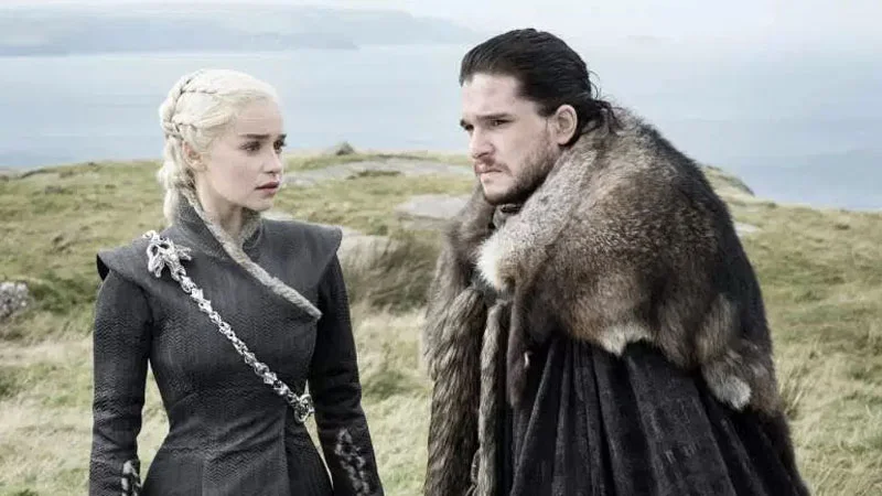 Daenerys Targaryen and Jon Snow share a charged moment on the cliffs of Dragonstone, the visual foundation of the 'Jonaerys' ship.