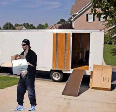 A Photoshop remix of the Sad Keanu meme depicting the actor mournfully moving a girl inside a cardboard box, one of many creative photo-edits that circulated in 2011.