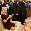 Tight framing emphasizing casual posture in formal White House setting.
