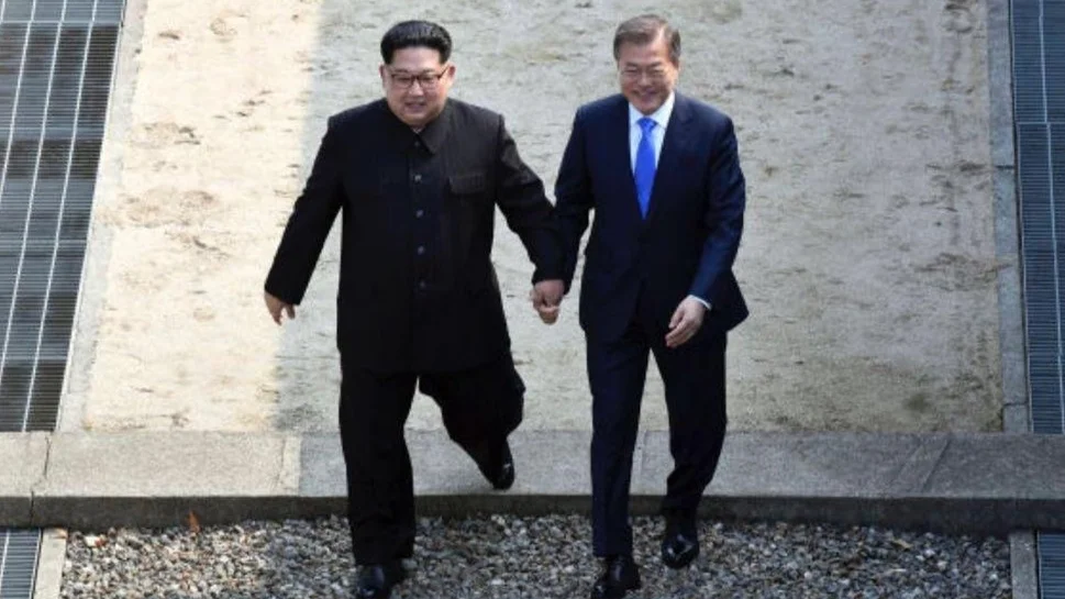 The now-iconic photograph of Kim Jong Un and Moon Jae-in crossing the inter-Korean border together during the April 27, 2018 summit, the source image for the meme.