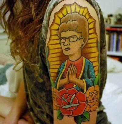 A fan tattoo depicting Peggy Hill styled after the Virgin of Guadalupe, showcasing King of the Hill's devoted fan culture.