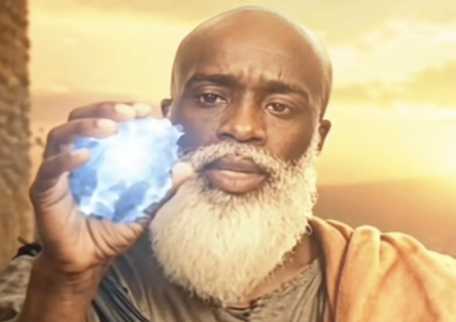 A serene bearded elder cradles a luminous blue lapis lazuli stone, the visual shorthand editors pair with Kai Cenat's 'la peace' mispronunciation to cast him as a monk imparting ancient wisdom.
