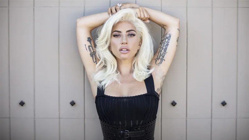Lady Gaga in a promotional portrait showcasing her signature blonde hair and edgy style.