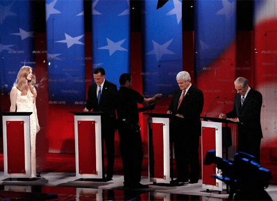 A meme GIF placing Lana Del Rey among Republican presidential candidates during a televised debate.