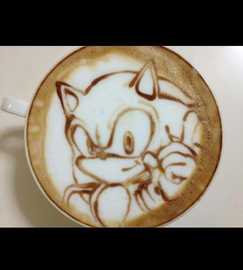 Sonic the Hedgehog rendered in remarkable detail as latte art, complete with his signature peace-sign pose.