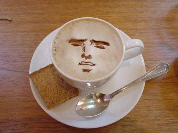 A finely etched portrait of a stern-looking man served with a biscotti on the side.