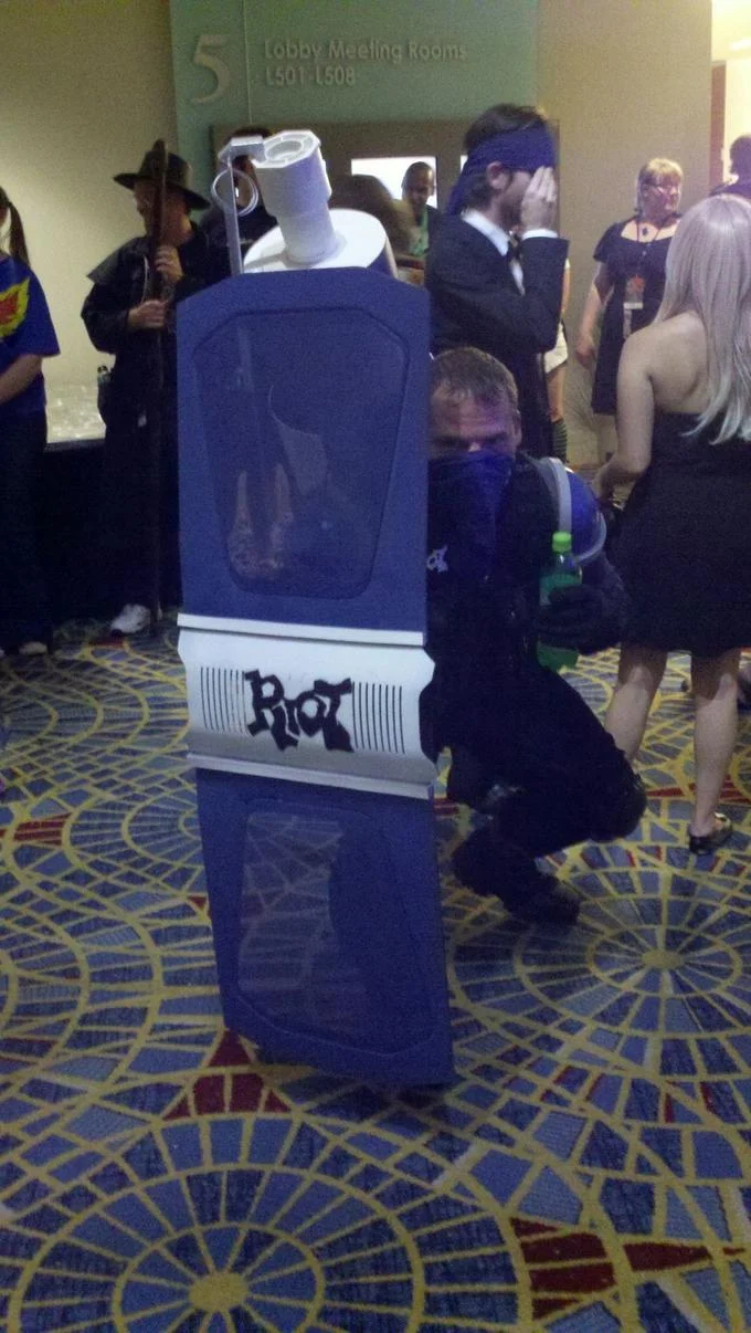 Cosplayers dressed as popular League of Legends champions at a gaming convention meet-up.