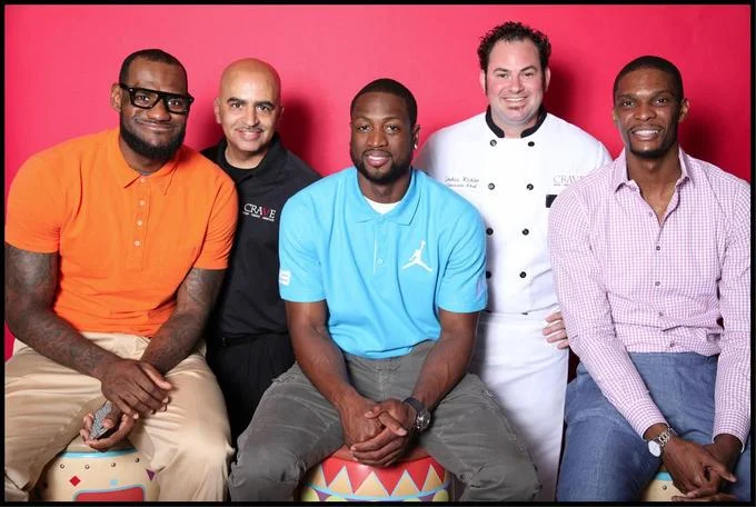 The source photograph from a CRAVE restaurant event featuring LeBron James in the now-iconic nerd glasses alongside Miami Heat teammates Dwyane Wade and Chris Bosh.