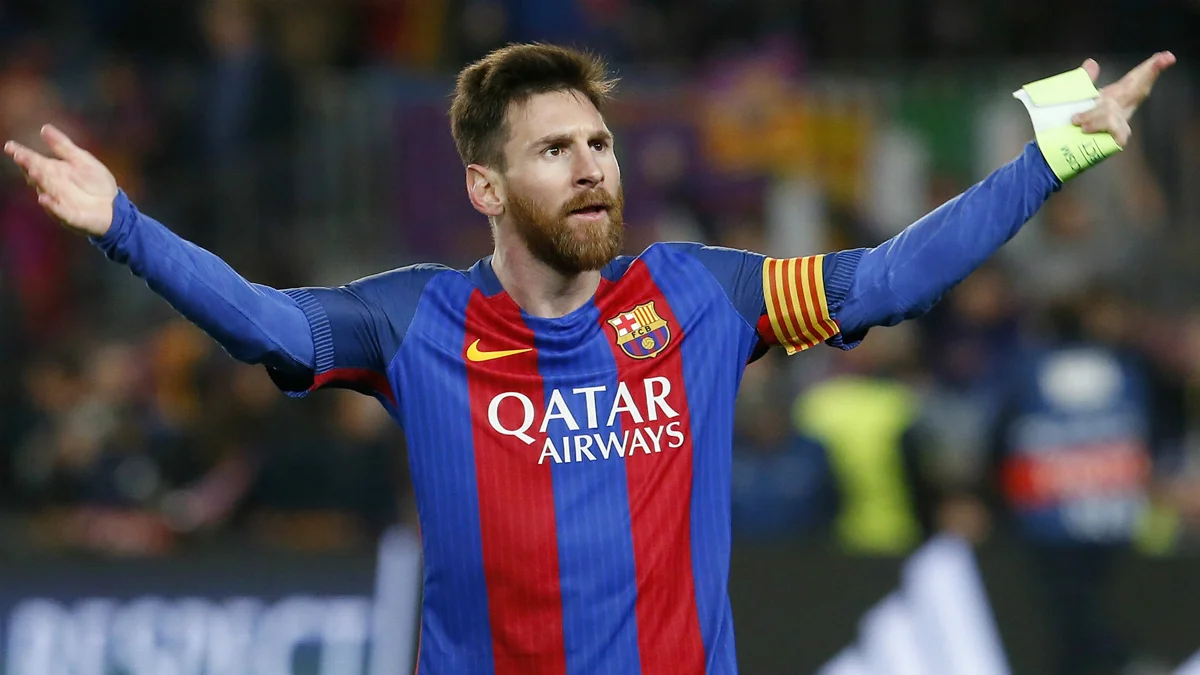 Lionel Messi celebrates during a match while wearing the FC Barcelona jersey and captain's armband.