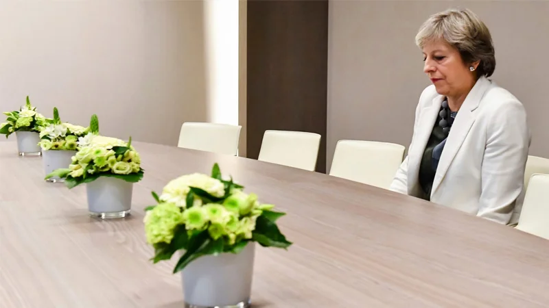The original press photograph of Theresa May sitting alone at a Brussels EU summit meeting table, which became the basis of the 'Lonely Theresa May' meme.