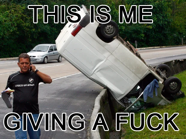 Real-world 'apathy' variant of the meme showing a man ignoring an overturned car, captioned 'This is me giving a fuck.'
