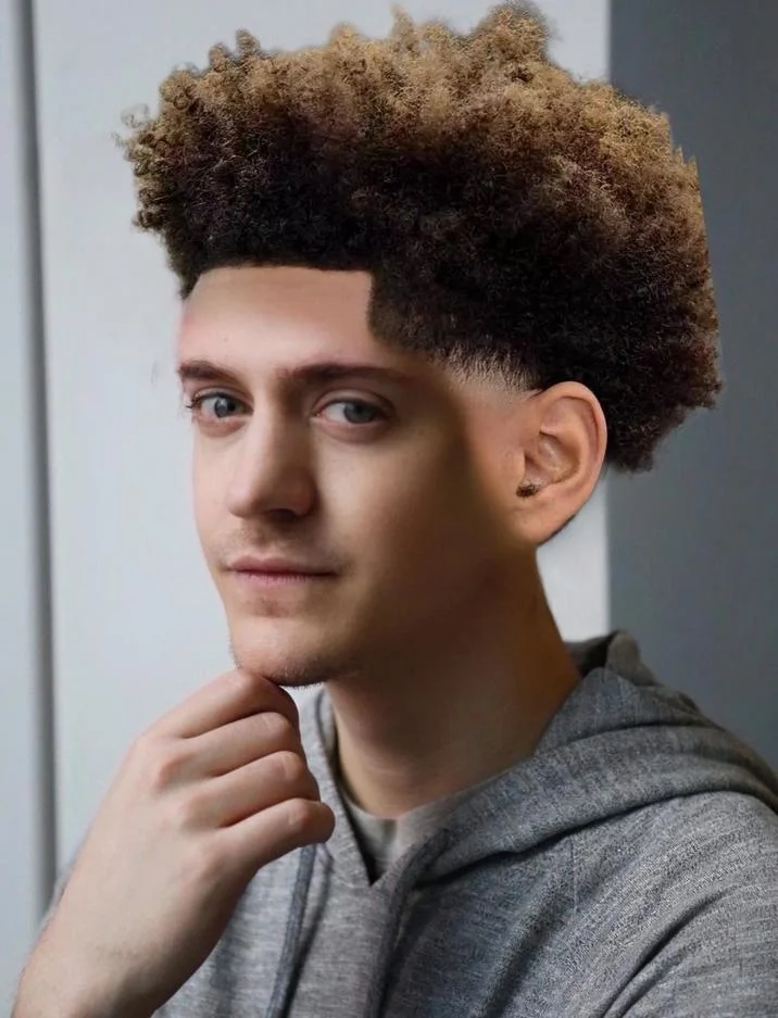 Professional portrait showcasing iconic low taper fade.