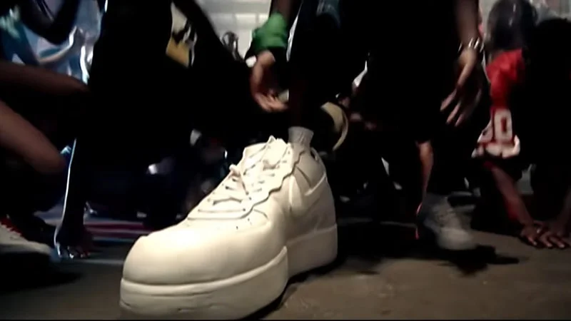 The clearest still frame of the iconic big shoe.