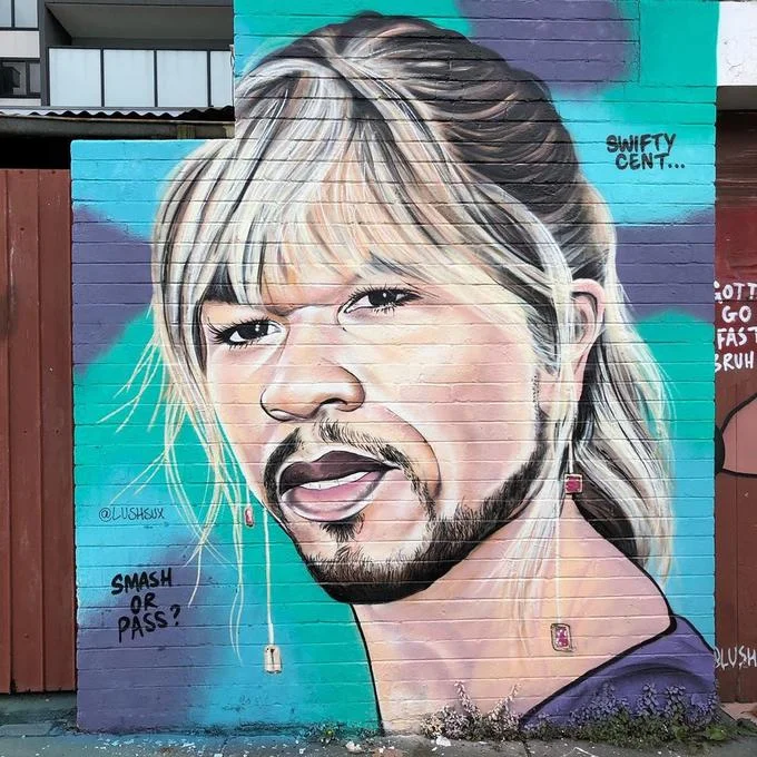A Lushsux portrait mural of rapper 50 Cent, tagged with the artist's signature Instagram handle.